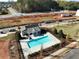 Aerial view of a community pool with a modern bathhouse and well-maintained landscaping in a new neighborhood at 4527 Moray Dr, Mableton, GA 30126