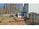 View of the backyard with a screened-in porch, stone patio, grill and partial fence at 5770 Millstone Dr, Cumming, GA 30028