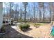 View of the backyard with a wooded area, patio, and grill at 5770 Millstone Dr, Cumming, GA 30028