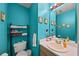 The colorful bathroom has modern fixtures, a vanity with sink, and ample storage at 5770 Millstone Dr, Cumming, GA 30028