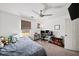 Neutral bedroom features a ceiling fan, a window, and space for bed and desk at 5770 Millstone Dr, Cumming, GA 30028