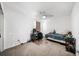 Neutral bedroom features a ceiling fan, and space for bed, desk, and shelving unit at 5770 Millstone Dr, Cumming, GA 30028