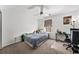 Neutral bedroom features a ceiling fan, a window, and space for bed and desk at 5770 Millstone Dr, Cumming, GA 30028