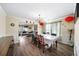 Dining room with hard surface floors, dining table, decorative light fixture, and access to other rooms at 5770 Millstone Dr, Cumming, GA 30028