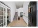 Inviting foyer with tile flooring, staircase, and neutral wall paint at 5770 Millstone Dr, Cumming, GA 30028