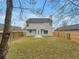 View of back exterior with siding, fenced yard and patio perfect for entertaining at 7006 Mahonia Pl, Lithonia, GA 30038