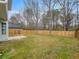 A spacious fenced backyard provides plenty of room, with mature trees lining the rear of the property at 7006 Mahonia Pl, Lithonia, GA 30038