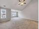 Carpeted bedroom with vaulted ceiling, ceiling fan, and large windows for ample natural light at 7006 Mahonia Pl, Lithonia, GA 30038