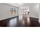 Open concept living space featuring wood floors, bright natural light, and neutral paint at 7006 Mahonia Pl, Lithonia, GA 30038