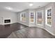 Cozy living room with a fireplace, hardwood floors, and windows with backyard views at 7006 Mahonia Pl, Lithonia, GA 30038