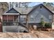 Back exterior of home featuring a screened porch and wooden deck at 5073 Hyacinth Ln, Austell, GA 30106