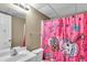 Bathroom featuring a white vanity, toilet and colorful shower curtain at 5073 Hyacinth Ln, Austell, GA 30106