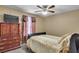 Cozy bedroom featuring carpet, ceiling fan and classic wood dresser with TV on top at 5073 Hyacinth Ln, Austell, GA 30106