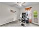 This bedroom features a desk area, carpet, ceiling fan and curtains at 5073 Hyacinth Ln, Austell, GA 30106