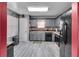 Well-lit kitchen featuring gray cabinets, black appliances, and a mosaic tile backsplash at 5073 Hyacinth Ln, Austell, GA 30106