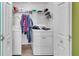 Functional laundry room with washer, dryer, and storage shelves at 5073 Hyacinth Ln, Austell, GA 30106