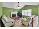 Cozy living room with vaulted ceilings, a fireplace, wood-look flooring, and neutral-toned furniture at 5073 Hyacinth Ln, Austell, GA 30106