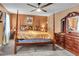 Beautiful main bedroom features ceiling fan and a four-poster bed with a dark wood dresser at 5073 Hyacinth Ln, Austell, GA 30106