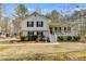 Charming two-story home featuring a front porch, landscaped yard and classic white siding at 673 Waters Rd, Hiram, GA 30141