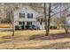 White split level home with a welcoming porch and mature trees dotting the front yard at 673 Waters Rd, Hiram, GA 30141