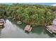 Aerial shot of lakefront property with docks and lush green surroundings at 7640 Harbour Walk, Cumming, GA 30041