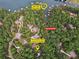 Aerial view of the property with a golf cart path and private boat dock, surrounded by lush green trees and lake at 7640 Harbour Walk, Cumming, GA 30041