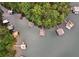 Aerial shot of multiple docks and lakefront properties surrounded by lush greenery at 7640 Harbour Walk, Cumming, GA 30041
