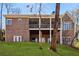 Expansive backyard featuring a brick home, a screened-in porch, and well-maintained lawn at 7640 Harbour Walk, Cumming, GA 30041