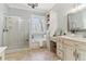 Well-lit bathroom featuring double vanity, soaking tub, and glass shower at 7640 Harbour Walk, Cumming, GA 30041