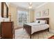 Comfortable bedroom with natural light, hardwood floors, and a ceiling fan at 7640 Harbour Walk, Cumming, GA 30041