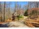 A well-maintained home with a winding driveway, beautiful landscaping and a charming wooden fence at 7640 Harbour Walk, Cumming, GA 30041