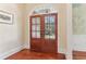 Inviting foyer featuring double doors, hardwood floors, and elegant trim work, showcasing a warm entry at 7640 Harbour Walk, Cumming, GA 30041