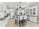 Spacious white kitchen with island, stainless steel appliances, and ample seating for casual dining at 7640 Harbour Walk, Cumming, GA 30041