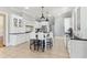 Well-lit kitchen with white cabinets, black countertops, large island with seating, and modern appliances at 7640 Harbour Walk, Cumming, GA 30041