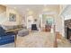 Cozy living room featuring a fireplace and open floor plan to the dining room at 7640 Harbour Walk, Cumming, GA 30041