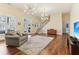Bright living room with hardwood floors, large windows, and a cozy seating area at 7640 Harbour Walk, Cumming, GA 30041