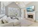 Bright living room with a vaulted ceiling, fireplace, and scenic outdoor views at 7640 Harbour Walk, Cumming, GA 30041
