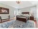 Main bedroom with trey ceilings, dark wood furniture and neutral walls at 7640 Harbour Walk, Cumming, GA 30041