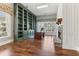 Elegant office with built-in bookshelves, a fireplace, and hardwood floors at 7640 Harbour Walk, Cumming, GA 30041