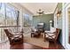 Relaxing screened-in porch with comfortable seating and view of the surrounding natural landscape at 7640 Harbour Walk, Cumming, GA 30041
