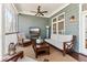 Relaxing screened-in porch featuring comfortable seating and a ceiling fan at 7640 Harbour Walk, Cumming, GA 30041