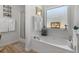 Bright bathroom featuring a garden tub, a glass shower, and ample natural light at 1152 Strath Clyde Way, Mcdonough, GA 30253