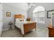 Cozy bedroom featuring vaulted ceiling, arched window, neutral paint, and wood-look flooring at 1152 Strath Clyde Way, Mcdonough, GA 30253