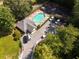 Aerial view of a community pool and tennis court surrounded by trees and a parking area at 1152 Strath Clyde Way, Mcdonough, GA 30253