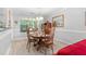 Charming dining room with a wood table set for four, bathed in natural light from the large window at 1152 Strath Clyde Way, Mcdonough, GA 30253