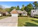 Charming brick home featuring a manicured lawn, arched window, and attached two-car garage at 1152 Strath Clyde Way, Mcdonough, GA 30253