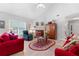 Comfortable living room featuring a brick fireplace, vaulted ceiling, and neutral-toned walls, creating a cozy atmosphere at 1152 Strath Clyde Way, Mcdonough, GA 30253