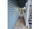 Exterior view of a light blue, covered balcony with white railings and stair access at 1644 Alexandria Ct, Marietta, GA 30067