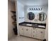 Elegant bathroom with double vanity, modern fixtures, and round mirrors at 1644 Alexandria Ct, Marietta, GA 30067