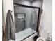Modern bathroom with a glass enclosed tub-shower, gray tiles, and neutral decor at 1644 Alexandria Ct, Marietta, GA 30067